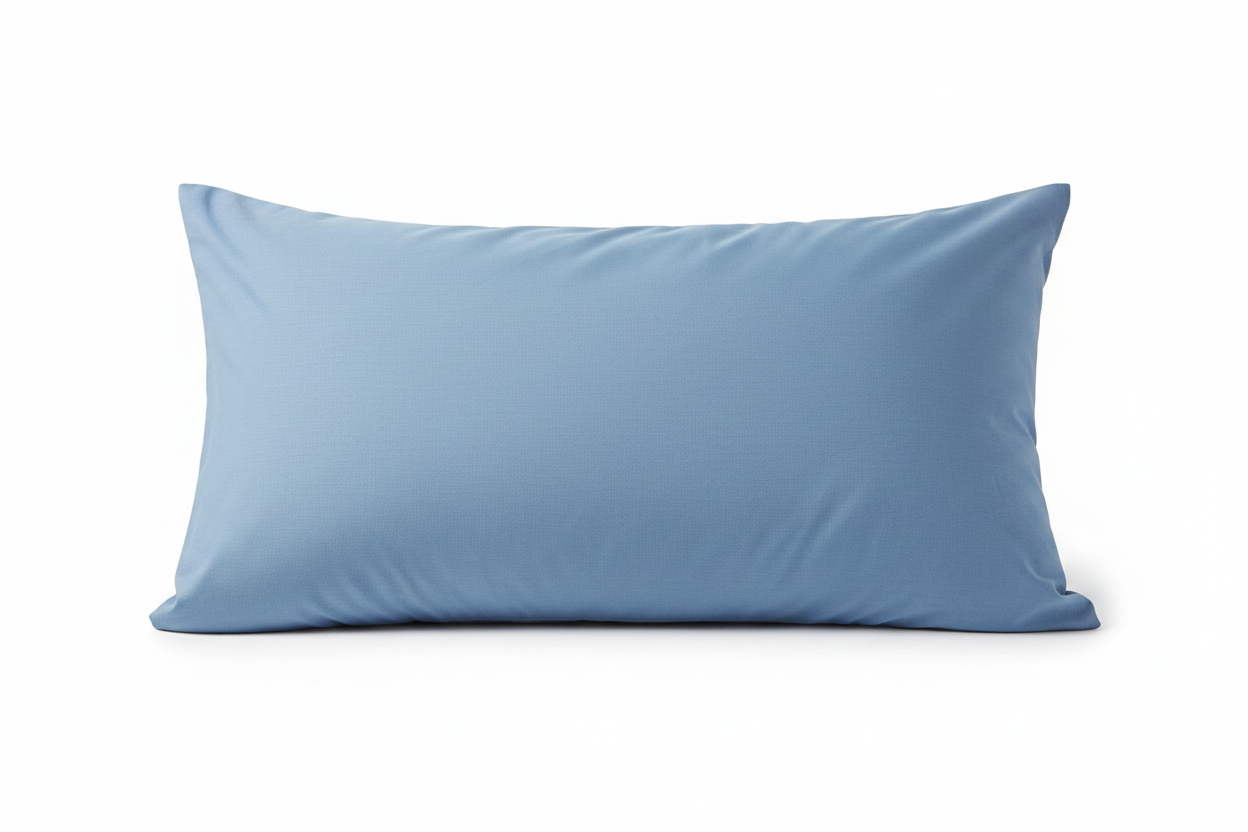 A light blue pillowcase on a bed with a wooden headboard and matching blue bedding.