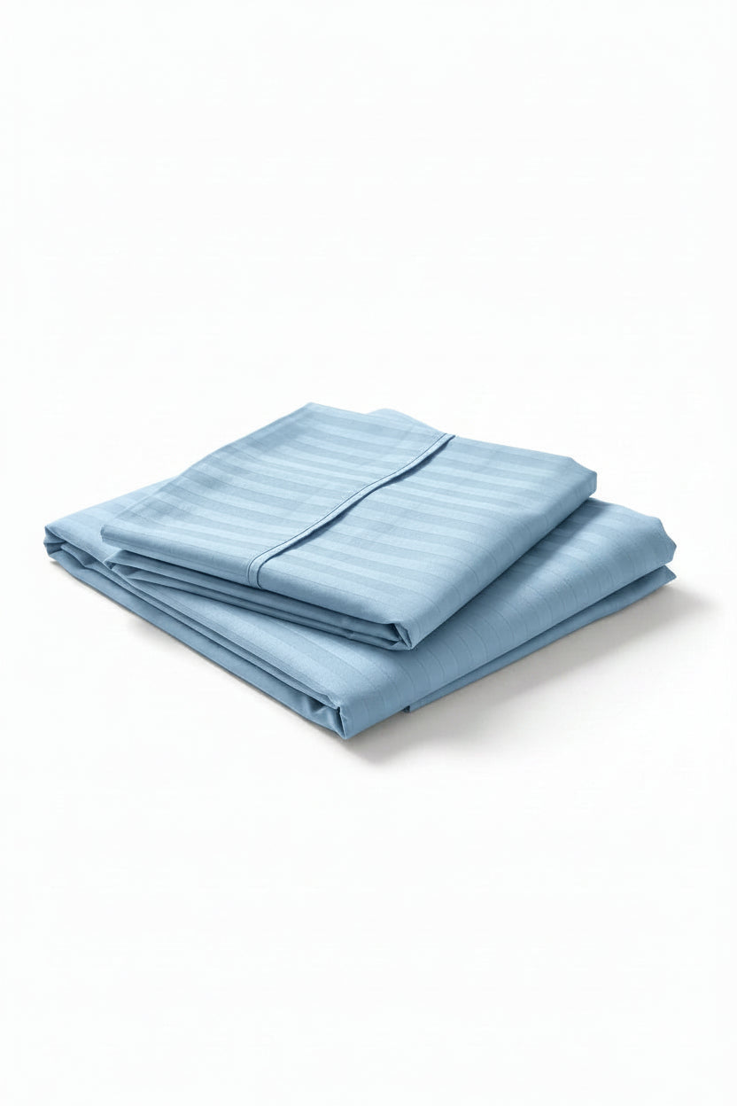 A folded light blue striped bedding sheet set placed on a white background.