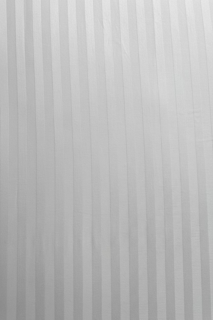 A close-up of a self-striped white fitted or flat 100% long-staple cotton sateen sheets
